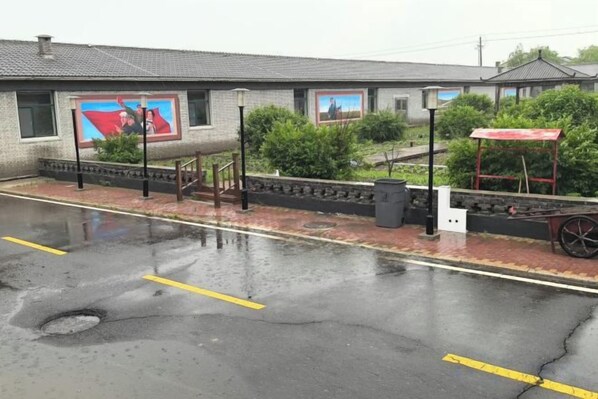 A building with a red awning, a wheelchair ramp, and a wheelchair accessible entrance.