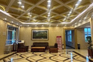 A lobby with a checkered floor, a large painting on the wall, and a reception desk. - Holiday Inn Wulagai Management Area (East Ujimqin Banner)
