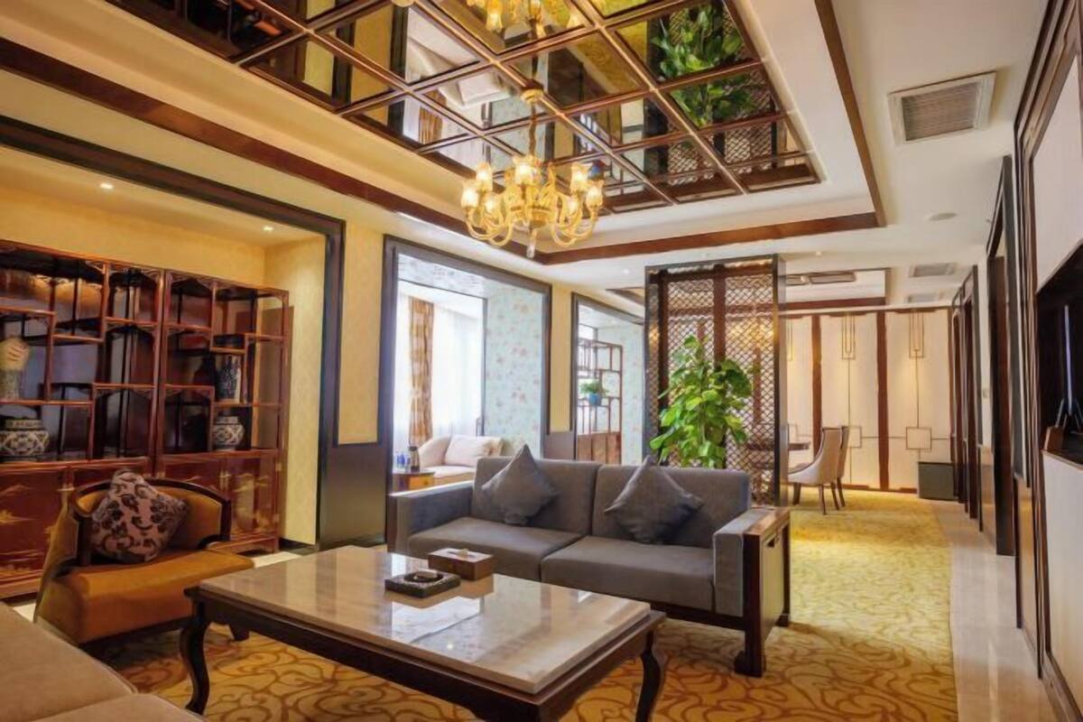 A spacious lobby with a sofa, coffee table, and a bookshelf.