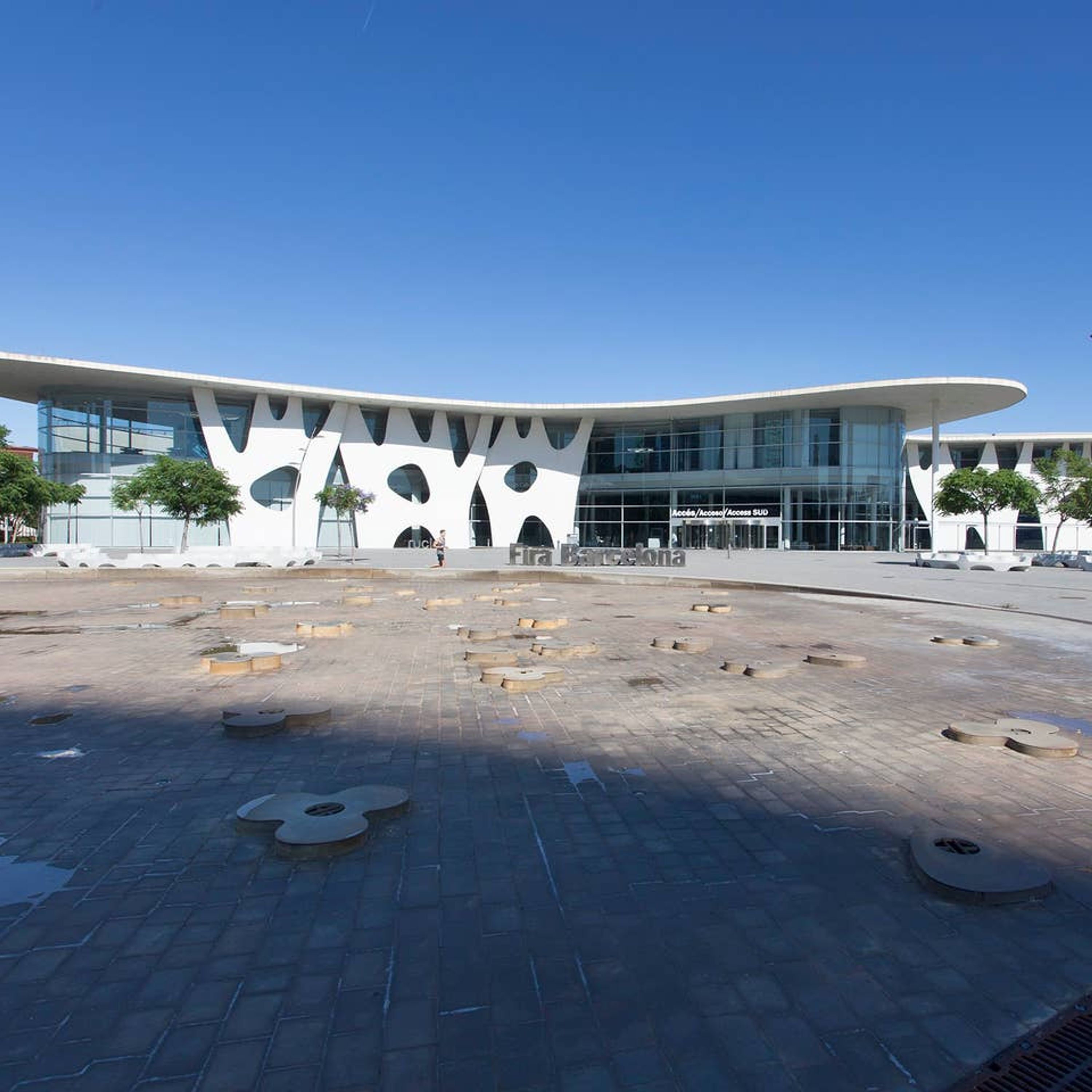 A modern building with a unique curved roof and large windows.