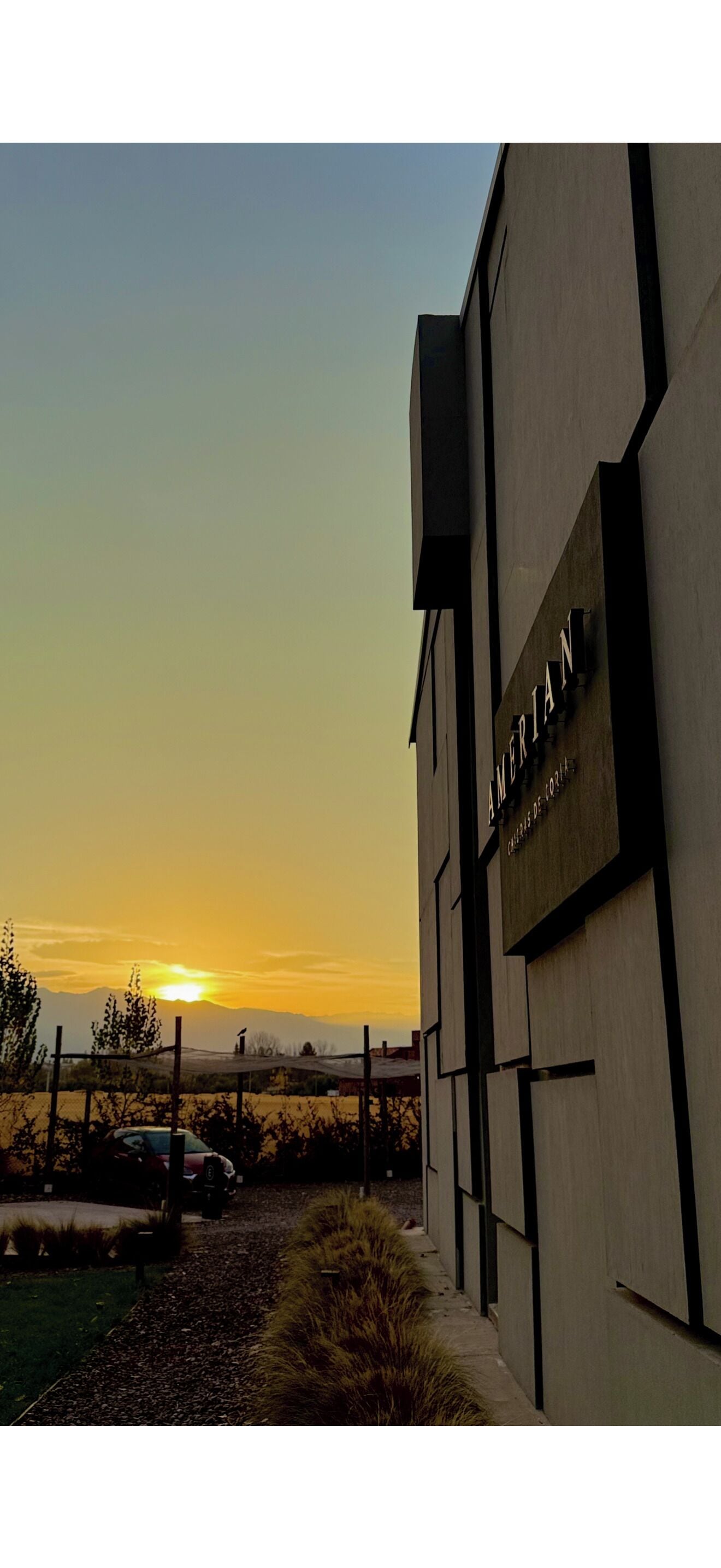 A building with a sign reading 'MARTIAN' and a sunset in the background.