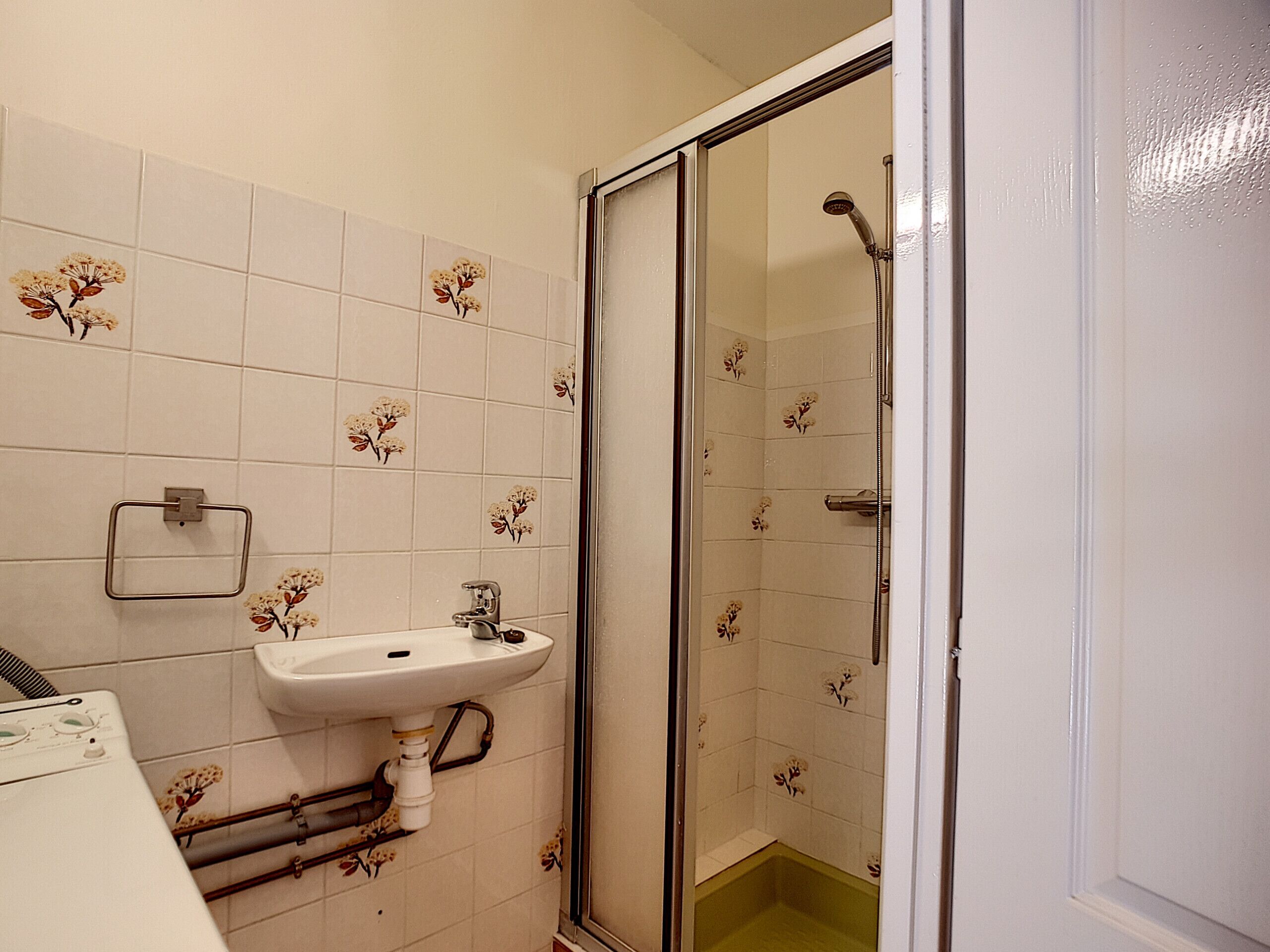 A bathroom with a sink, a toilet, and a shower enclosure.