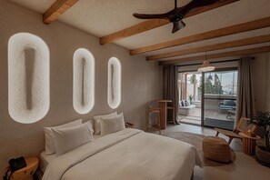 A bedroom with a large bed, wooden beams, a ceiling fan, and a view of the outdoors. - Serab Residencia (Jounieh)