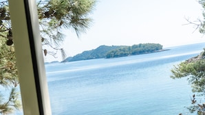 A view of a calm lake with a small island in the distance. - Seafront Apartments Olivera (Blato)