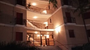A multi-story building with balconies and staircases.