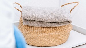 A woven basket with a fluffy beige cover, placed on a white surface. - Serious Job Room (Dubrovnik)