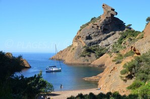 A rocky coastal landscape with a clear blue sky. - "Le Pégase" (La Ciotat)