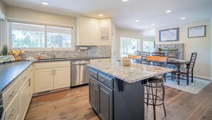 A modern kitchen with granite countertops, stainless steel appliances, and a large island.