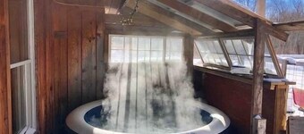 Rustic cabin w/ 29 acres. Enjoy a hot tub, wood stove, nature trails and more.