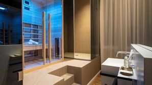 A modern bathroom with a glass shower enclosure, a sink with a tray, and a mirror. - Amorgiù Luxury Room (Palermo)
