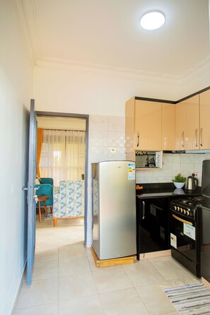 Fridge, microwave, oven, stovetop - Inviting 2-bed Apartment in Sseta, Mukono (Seeta)