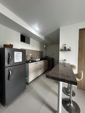 Fridge, coffee/tea maker, cookware/dishes/utensils, kitchen islands