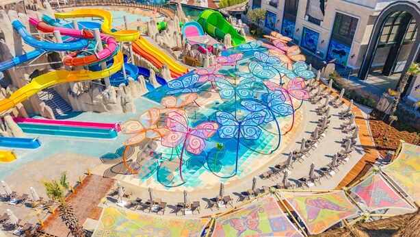 A water park with multiple slides and a pool area. - The Land of Legends Nickelodeon Hotels Antalya (Serik)