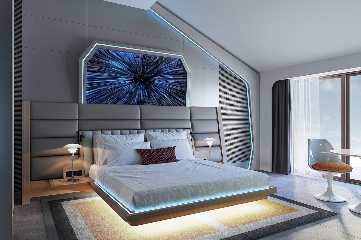 Une chambre moderne avec un grand lit, un écran numérique fixé au mur et une vue sur le ciel par la fenêtre.