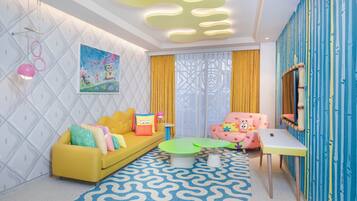 A vibrant living room with a yellow sofa, green coffee table, and a pink chair.