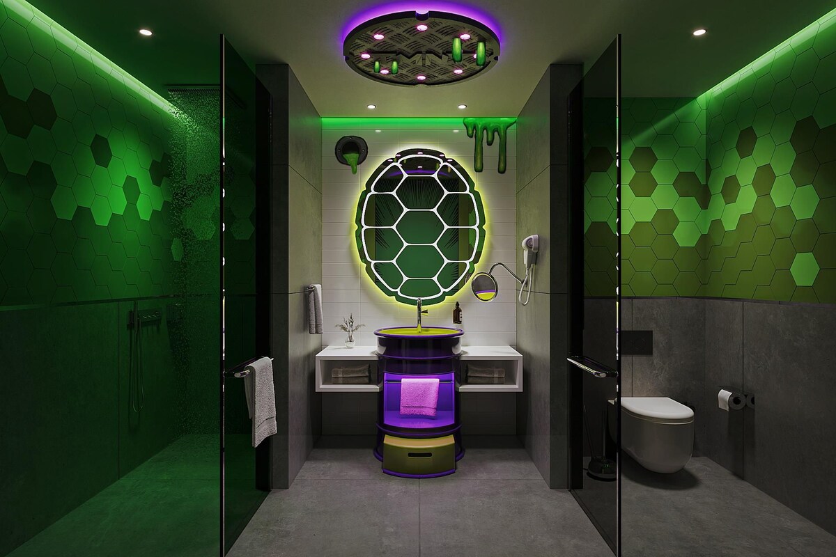 A modern bathroom with a hexagonal mirror, a pedestal sink, and a toilet.
