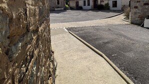 A courtyard with stone buildings, a paved walkway, and a clear sky. - Gite with heated indoor pool on the Opal Coast (Tingry)