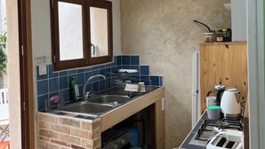 A compact kitchen with a skylight, a built-in oven, a gas stove, and a toaster. - 1 Bedroom Private vacation home in SoulignÃ©-sous-Ballon (Souligné-sous-Ballon)