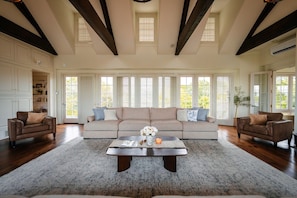 A spacious living room with a large sofa, two armchairs, a coffee table, and a fireplace. - Roundtop Mansion Breathtaking View indoor Pool (Wrightsville)