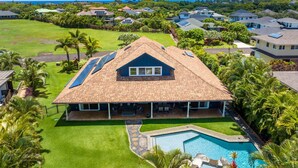 A residential property with a swimming pool, solar panels, and a view of the ocean. - NEW LISTING - Nani Hale, 4 bed, AC, pool & jacuzzi (Koloa)