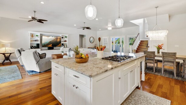 A spacious kitchen with a large island, white cabinetry, and modern pendant lighting. - NEW LISTING - Nani Hale, 4 bed, AC, pool & jacuzzi (Koloa)