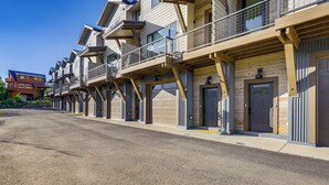 A row of modern multi-story buildings with balconies, large garage doors, and a clear sky. - Peaceful Crested Butte Townhome w/ Mountain Views (Crested Butte)