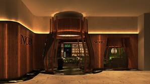 A lobby with wooden walls and a central staircase.