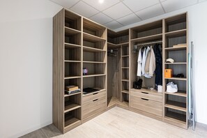 Organized storage space with multiple shelves and drawers.