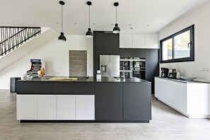 Enjoy cooking and entertaining in this well-equipped kitchen with a central island and ample counter space.