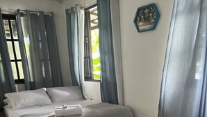 A hotel room with two beds, a window with curtains, a wall clock, and a tiled floor. - Praia Comprida Flats (Angra dos Reis)