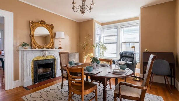 A dining area with a fireplace, a chandelier, and a large mirror. - Stylish comfortable period feature 2 bed - Sun drenched - Free parking (Providence)