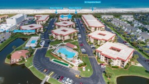 An aerial view of a resort with multiple buildings, a pool, and a beach walkover to St. Augustine Beach. - Ocean and Racquet #5217 (St. Augustine)