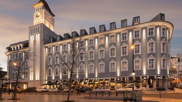 A historic building with a clock tower, multiple windows, and outdoor seating areas. - Gary01 Exclusive Top Floor 2BD by the Timeout Market (Lisbon)