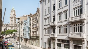 A street view with historic buildings, a prominent clock tower, and a clear sky. - Rivol6 · Amazing Flat Next to Rivoli (Porto)