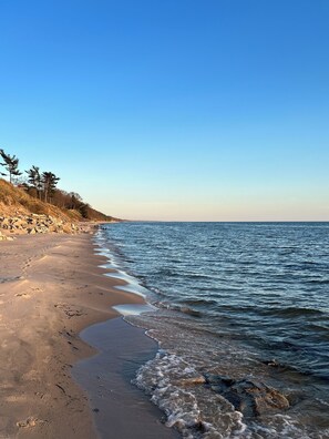 Enjoy a serene beach experience with gentle ocean waves lapping against the shore.