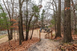 Stroll through the serene park, surrounded by a mix of deciduous and coniferous trees, and enjoy a family-friendly atmosphere with a playground nearby.