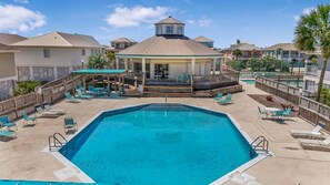 Relax by the resort pool surrounded by lounge chairs and a covered seating area.