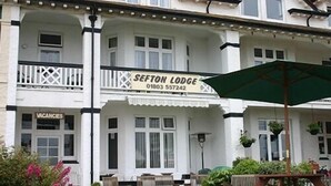 A two-story building with a sign for 'SEFTON LODGE' and a 'VACANCIES' sign below. - Sefton Lodge  (Paignton)