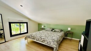 A bedroom with a bed, a window, a nightstand, and a TV. - Le Petit *** - 1 room, all new & all inclusive (Montauban)
