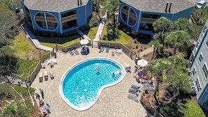An aerial view of a residential area with two blue houses, a swimming pool, and surrounding greenery. - Oceanfront Oasis Epic Views St Aug Free Tix (St. Augustine)