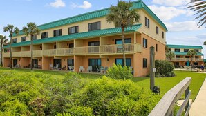 A multi-story hotel with a green roof, multiple balconies, and outdoor seating areas. - Sea Haven 221 Oceanfront Pool Comfort (St. Augustine)