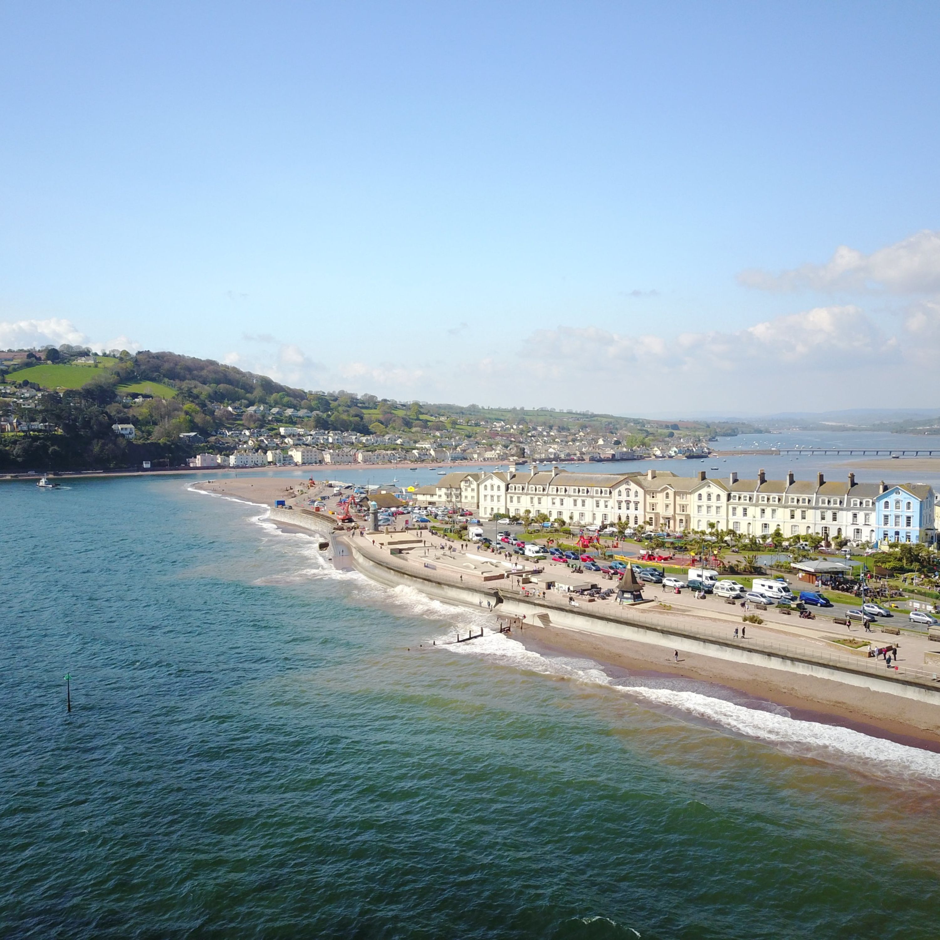 A coastal town with a promenade, beachfront, and buildings along the shore.