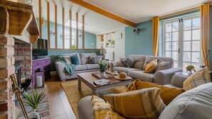Una sala de estar acogedora con chimenea, sofás y una mesa de centro.