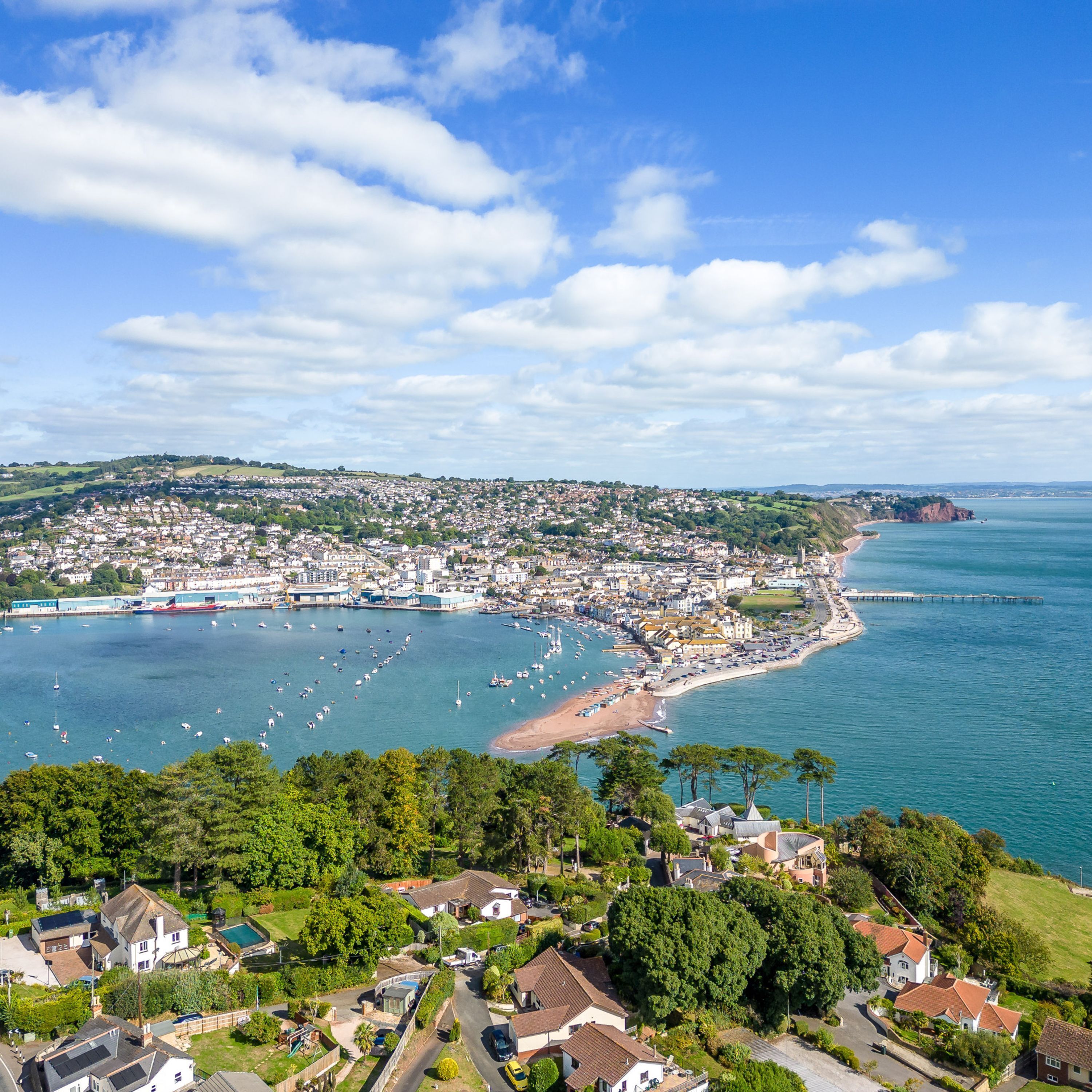 A coastal town with a marina, beach, and residential areas.