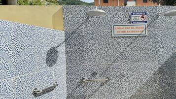 A tiled gate with a sign encouraging water conservation.