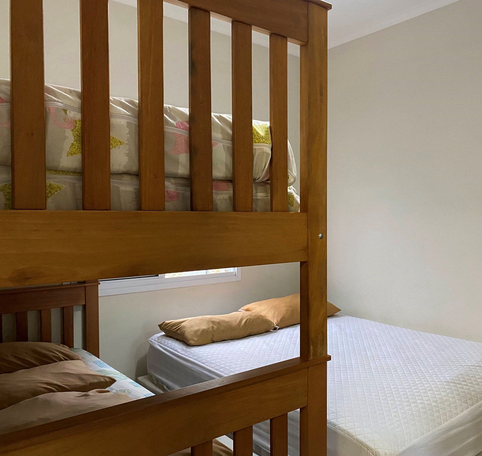 A bunk bed with a lower bunk and a single bed.