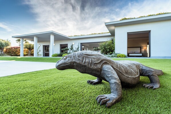 A modern house with a large garage door and a well-maintained lawn.