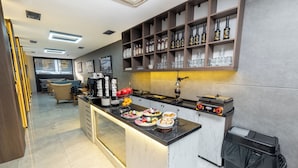 A modern kitchen with a marble countertop, a built-in wine cooler, and a variety of food items. - Luxury Life Suites (Istanbul)