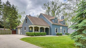 A two-story house with a front porch, a garage, and a well-maintained lawn. - Walkable Thiensville Retreat Near Hiking! (Mequon)