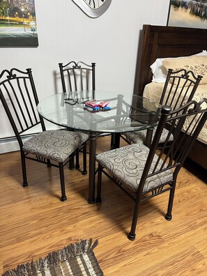 Enjoy meals in this cozy dining area with a round table and comfortable seating for four.